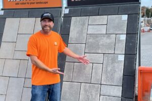 Photo of a person standing in front of a display of Triple H Concrete's new Premium Highthorn pavers.